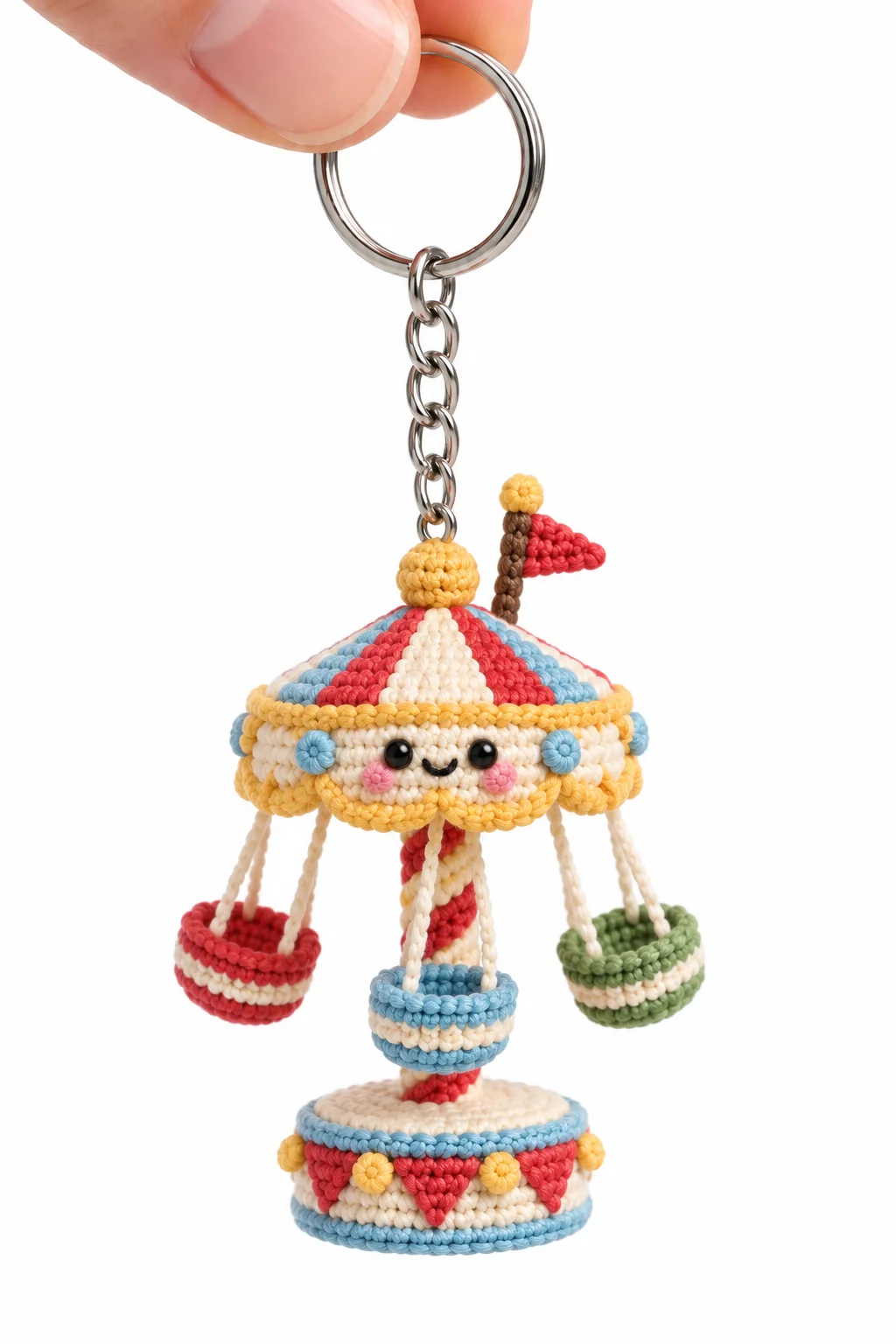 Crochet swing carousel keychain with a red, white and blue striped canopy, candy-striped pole and hanging red, blue and green seats