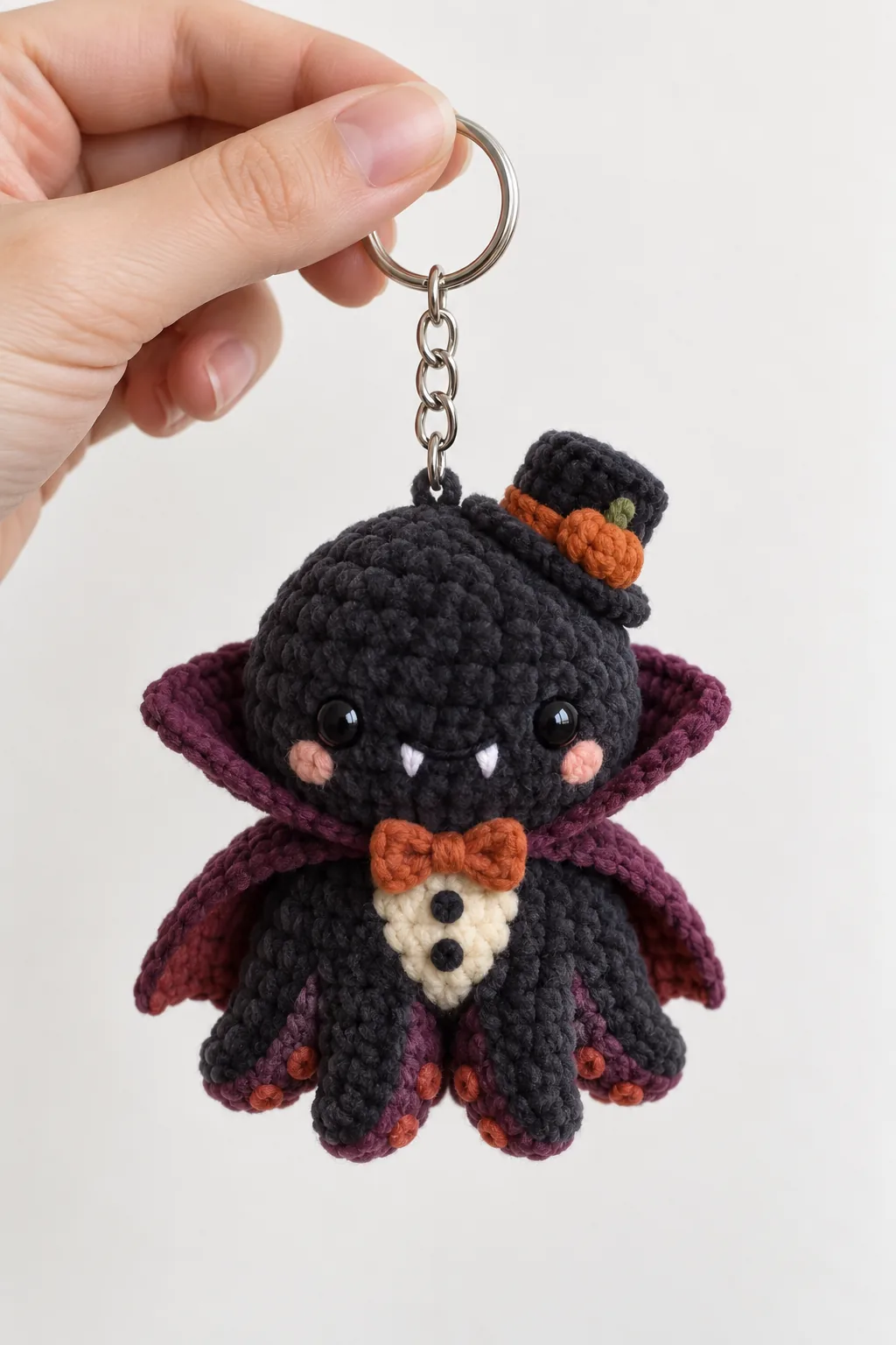 Vampire octopus in a cape and top hat crochet keychain