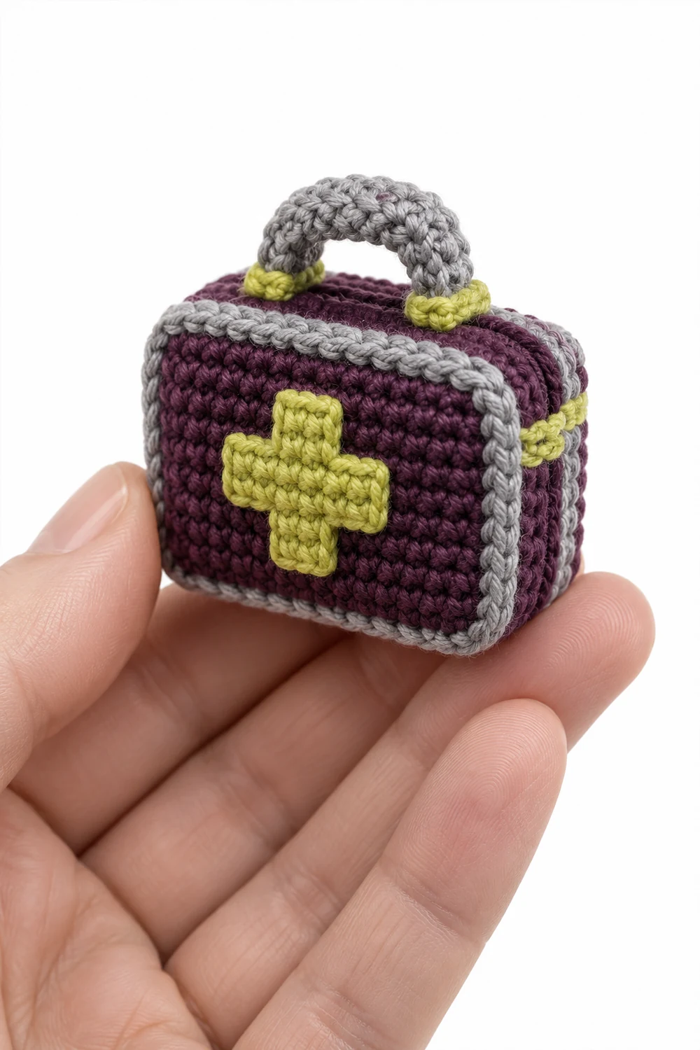 Aubergine miniature crochet first aid case with raised cross