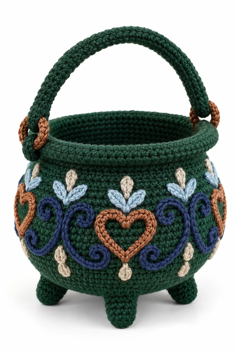 Forest green crochet cauldron-shaped treat basket with ice blue and oatmeal details