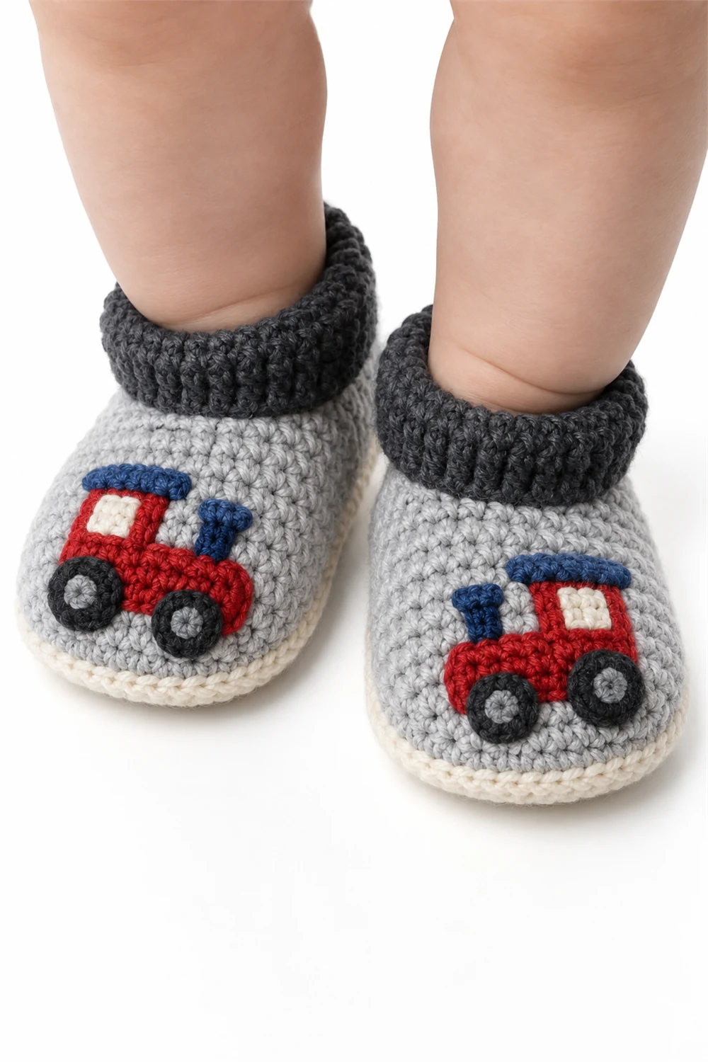 Gray crochet baby booties with cute train locomotive motif