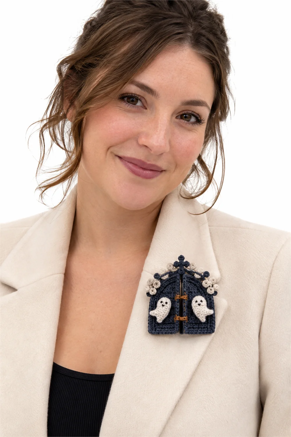 Navy blue crochet brooch shaped like a gate wrapped in fog