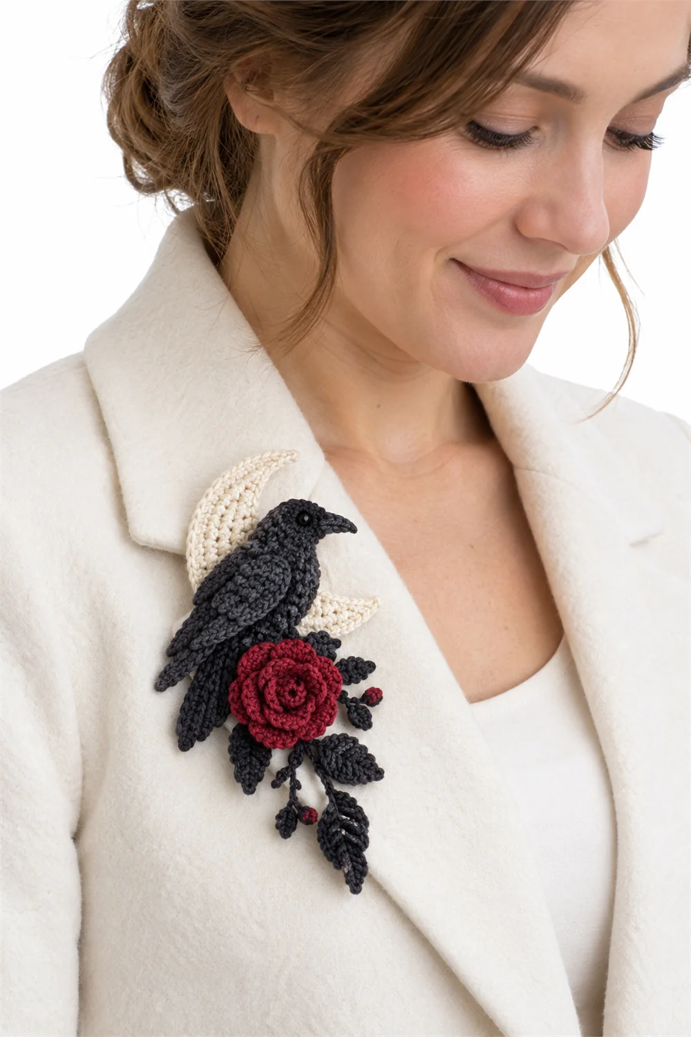 Dusty rose crochet brooch shaped like a doorway guarded by a raven
