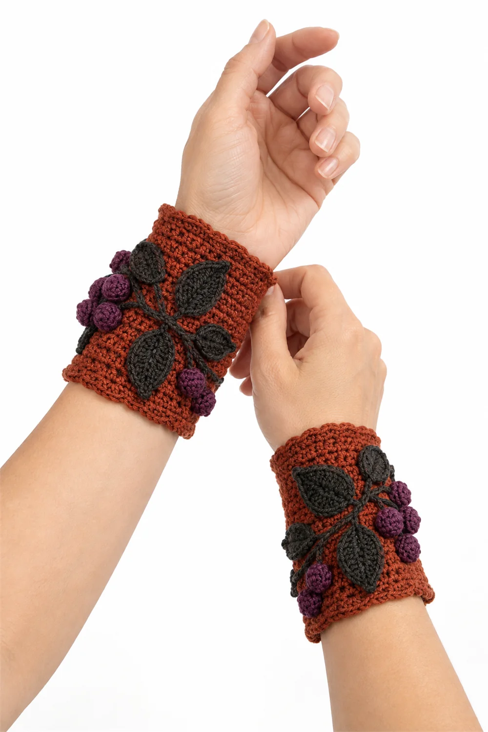 Rust orange crochet wristlets with nightshade vine pattern for Halloween