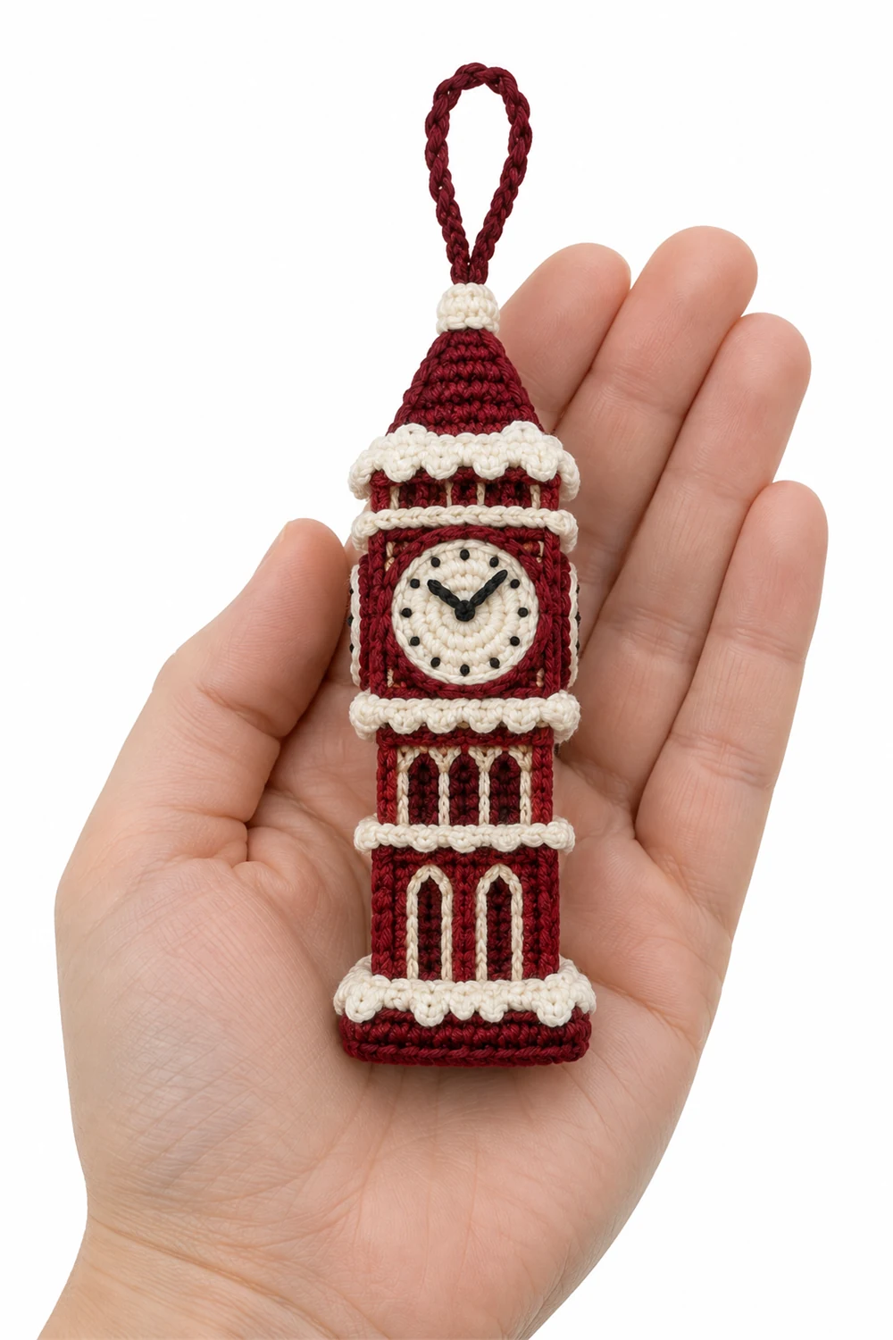 Crochet clock tower ornament with snowy roof and midnight clock face